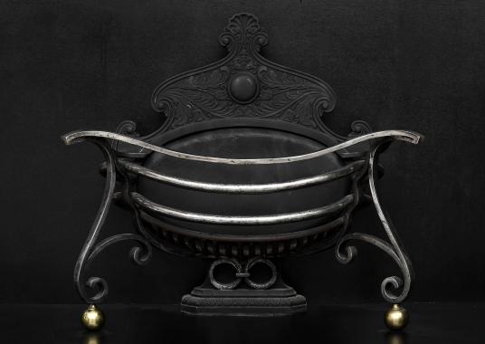 An unusual shaped Art Nouveau wrought iron firebasket