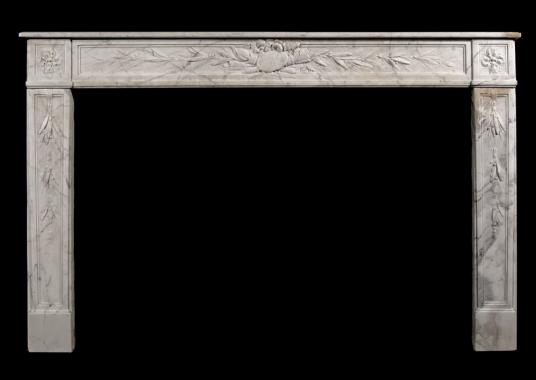 An 18th century French Louis XVI veined white marble fireplace