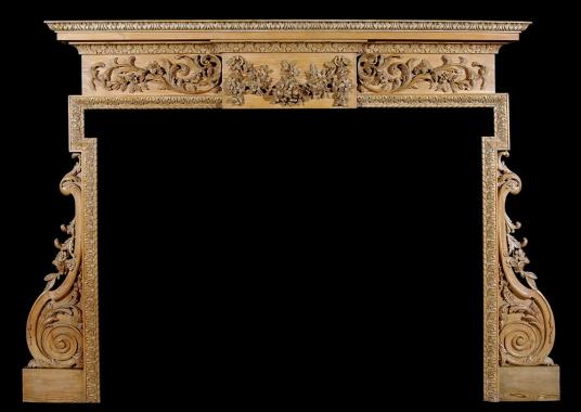 A carved English George III style pine fireplace