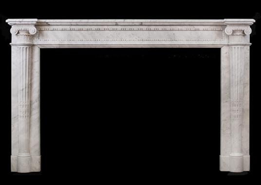A very finely carved French Louis XVI mantlepiece in Carrara marble