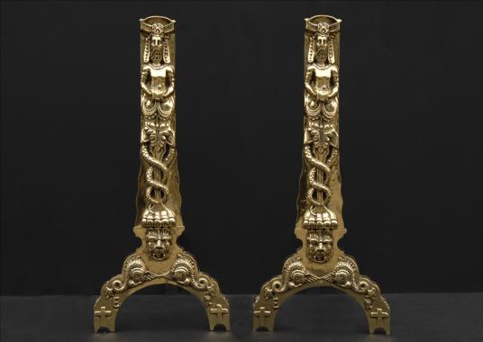 A large pair of decorative firedogs in the 17th century style