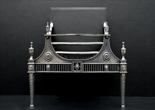 A Georgian style polished cast iron firebasket