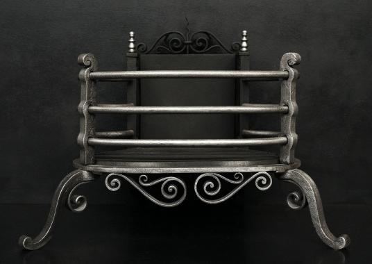 A polished iron Arts and Crafts firegrate