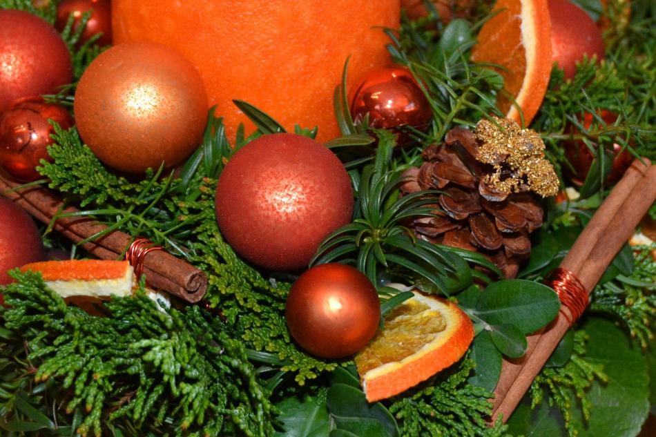 Christmas decoration with baubles, greenery, and dried fruit
