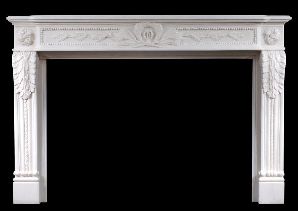 A Carved French Louis XVI Style White Marble Fireplace