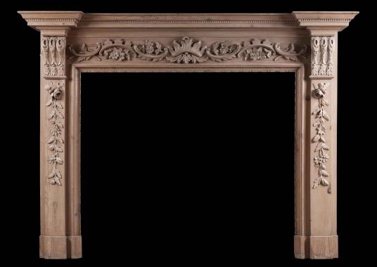 An English pine fireplace with carved fruit and foliage