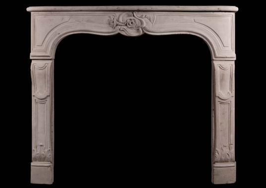 A period 18th Century French Louis XV Limestone Fireplace
