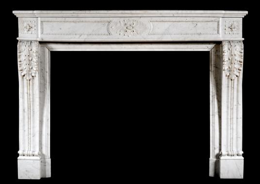 A French Louis XVI style antique fireplace in Carrara marble