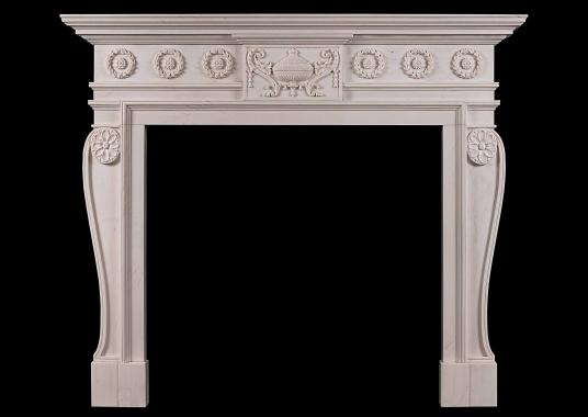 A late Georgian style carved chimneypiece in white marble