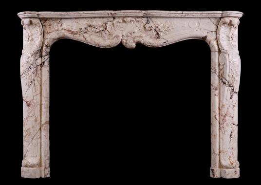 A Louis XV antique fireplace in a variegated marble