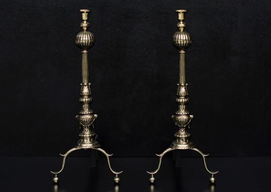 A pair of English brass firedogs with gadrooned finials