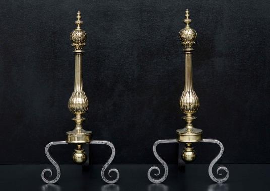 A pair of polished brass and wrought iron firedogs