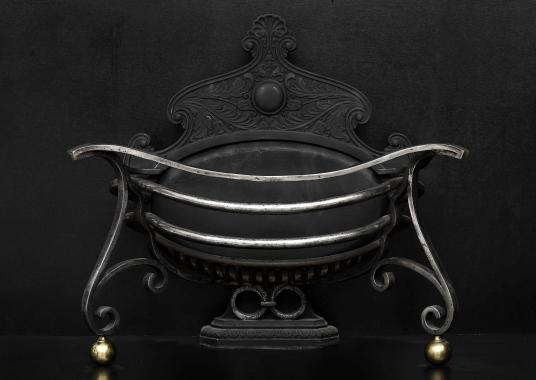 An unusual shaped Art Nouveau wrought iron firebasket