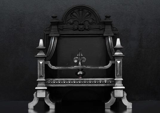 A polished cast iron firebasket in the Gothic style