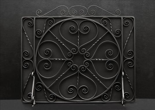 A large English wrought iron firescreen