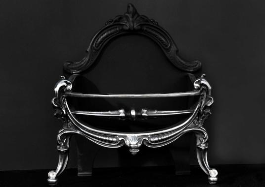 A polished cast iron firebasket in the Rococo manner