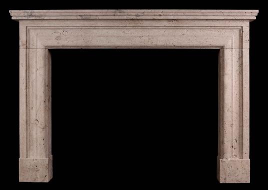 An imposing English bolection fireplace in Travertine stone