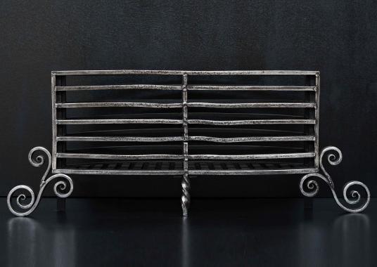 A polished Arts and Crafts wrought iron firegrate
