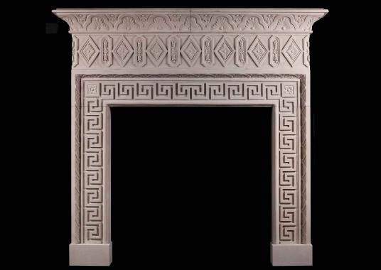 A large limestone chimneypiece with classical Greek key motif