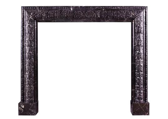 An elegant carved bolection fireplace in Nero Marquina marble