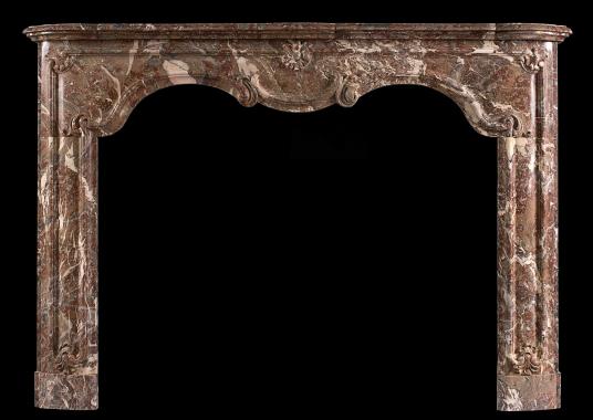 A period 18th century Louis XIV/XV transitional fireplace in Languedoc marble