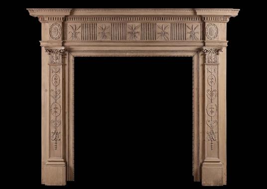 An 18th century carved pine fireplace in the Adam style