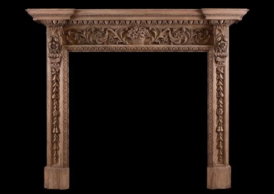 An ornate pine fireplace with carving throughout