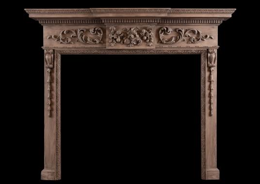 A carved English pine fireplace