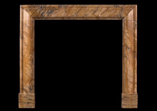 A petite Siena marble bolection fireplace