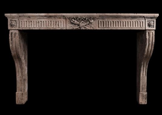 A period Louis XVI carved limestone fireplace