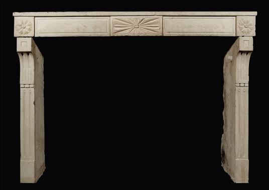 A rustic 18th century French Louis XVI stone fireplace