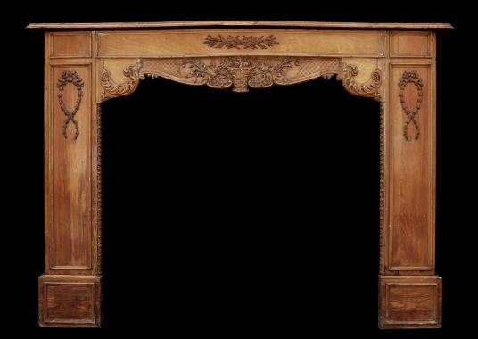 A late 19th / early 20th century English carved wood fireplace