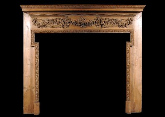 A 19th century George III style pine chimneypiece