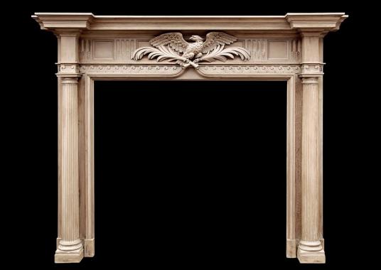 A Neo-Classical English pine fireplace with carved eagle to frieze