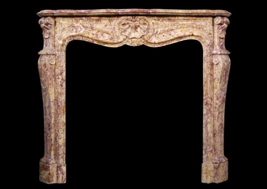 A French Louis XV style fireplace in Spanish Brocatelle marble