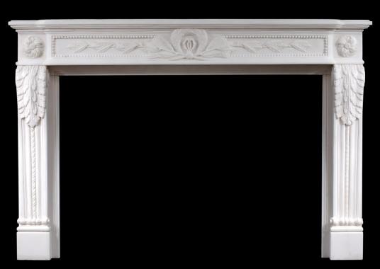 A carved French Louis XVI style white marble fireplace