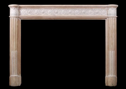 A French Louis XVI style wood fireplace with composition enrichments