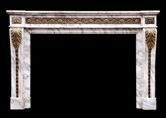 A Louis XVI style Arabescato marble fireplace with brass ormolu enrichments