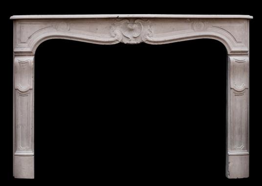 A 19th century French Louis XV style limestone fireplace