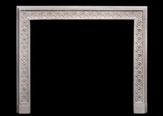 An attractive English limestone fireplace with guilloche carving