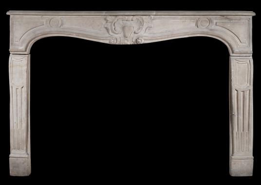 A 19th century French limestone chimneypiece in the Louis XV style