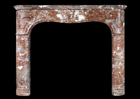 An 18th century French Louis XV fireplace in Languedoc marble