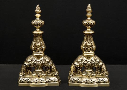 A pair of decorative brass firedogs