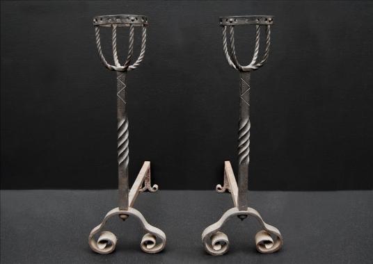 A pair of wrought iron firedogs