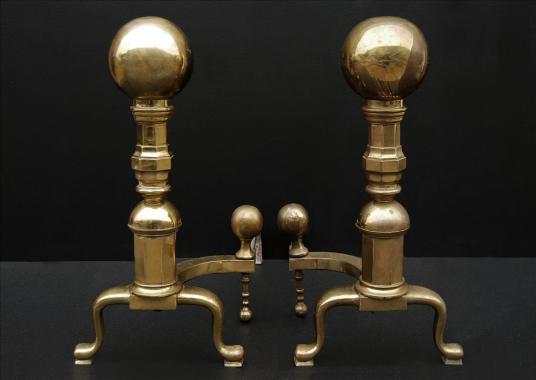 A very large and impressive pair of brass firedogs with ball tops