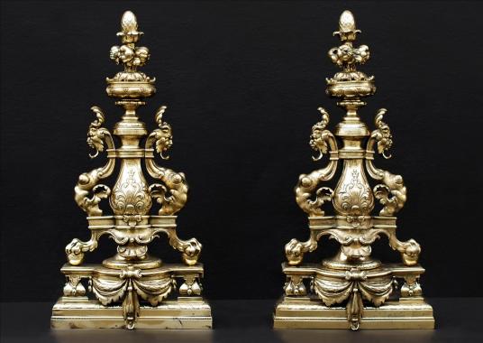 A decorative pair of English brass firedogs