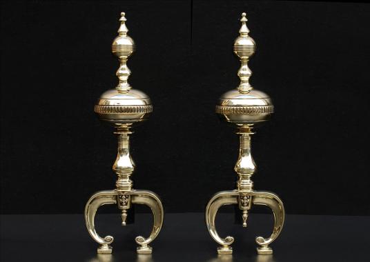 A pair of English brass firedogs