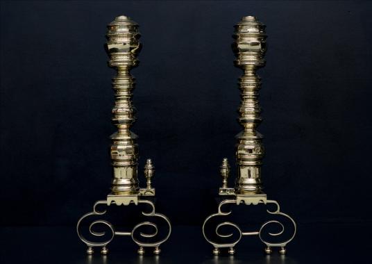 An impressive pair of brass firedogs