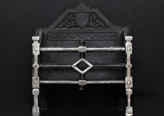An English steel fire basket in the Gothic manner