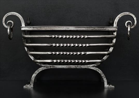 An Arts and Crafts wrought iron firebasket